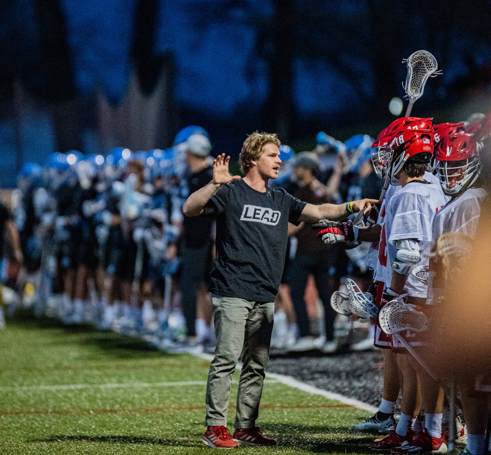 Coach McGuire directing players on the sideline at the University of Lynchburg